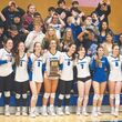 La Conner volleyball team holding trophy and flanked by fans.