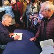 Author Timothy Egan signs books for readers
