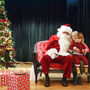 Two children by Santa on stage.