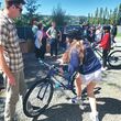 A man helps children with their new bikes