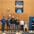 Attendees under the banner in the gym.