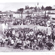 Old black and white photo of people from La Conner posing by waterfront.