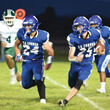 La Conner football players running the ball.
