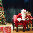 Two children by Santa on stage.
