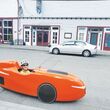 A man sits in his three-wheeled, pedal-powered velomobile