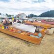 Traditional Native American canoes are shown on a beach