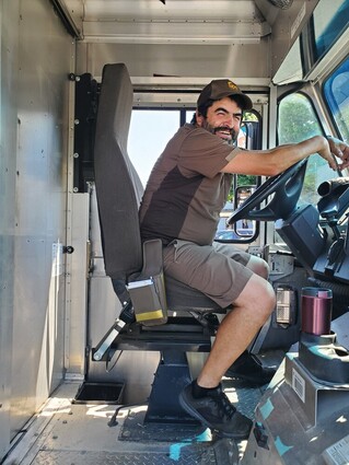 UPS driver Hector Soltero sits behind the wheel of his delivery truck