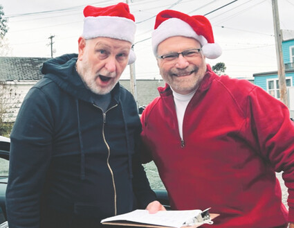 John Leaver and Bob Ferari wearing Santa hats.
