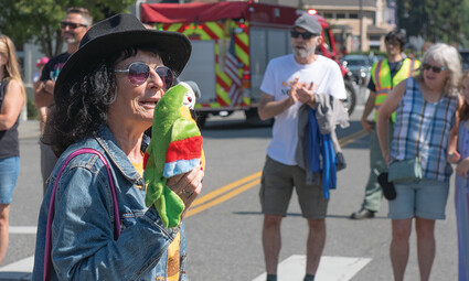 Gerri Roche holding parrot puppet.