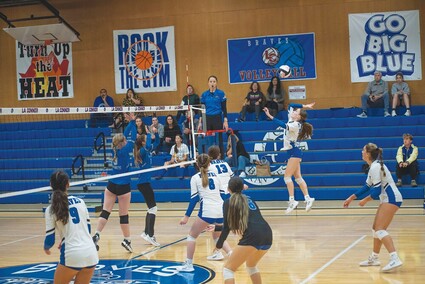 Player Maeve McCormick spiking the volleyball.