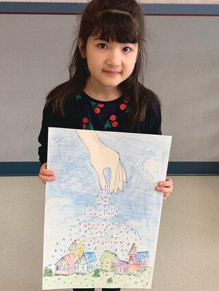 A girl shows her poster