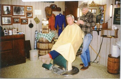 A barber cutting a customer's hair.