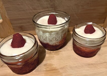 three cups of yogurt with raspberries