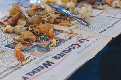 Crab and shrimp shells on top of La Conner Weekly News paper.