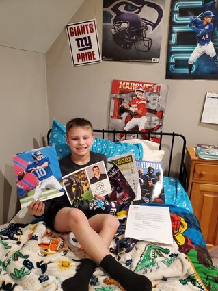 Boy poses with NFL swag
