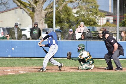 Baseball player swings at a pitch