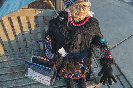 Photo of mannequin fortune teller on bench.